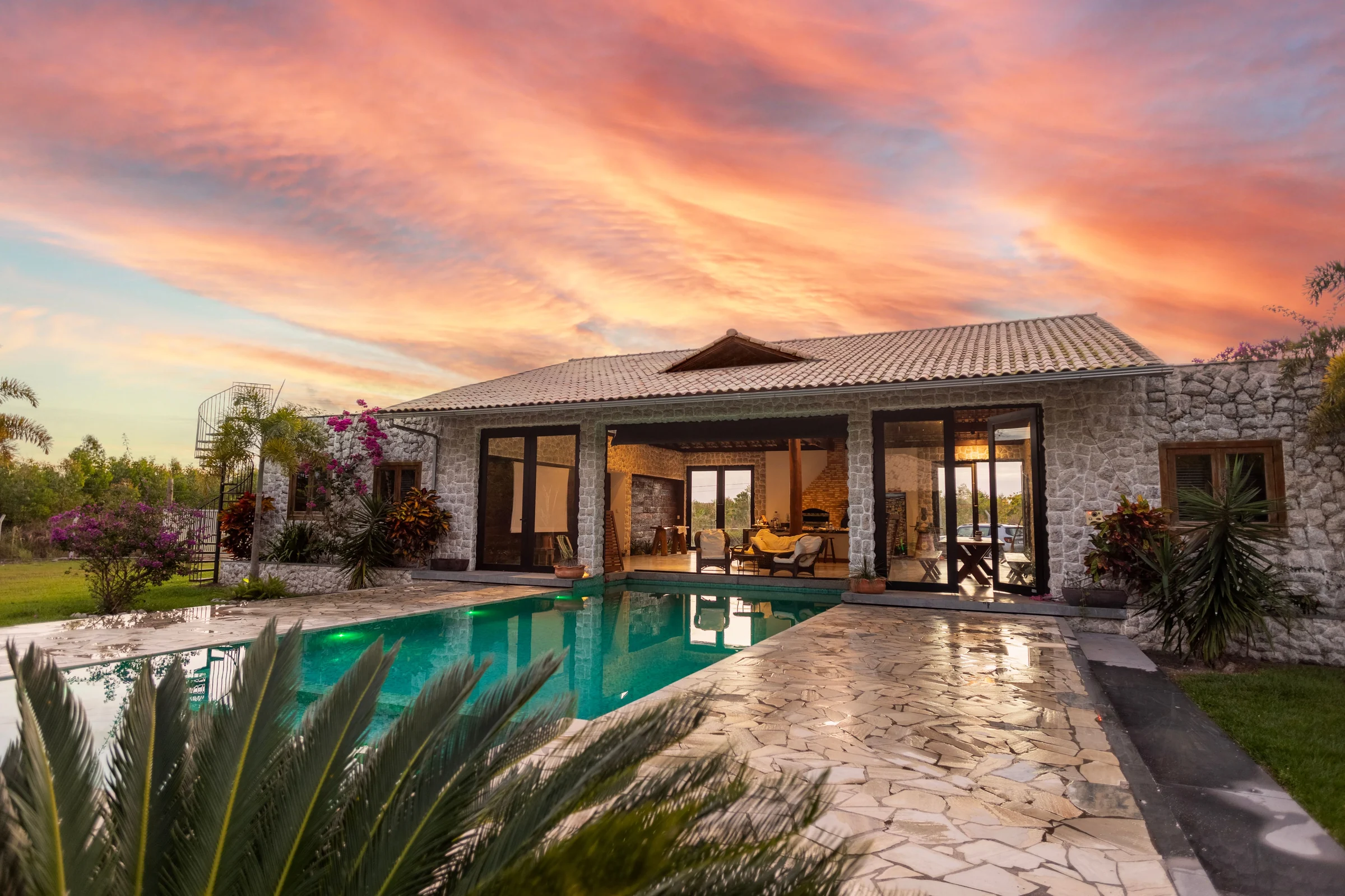 Stone villa with a pool at sunset